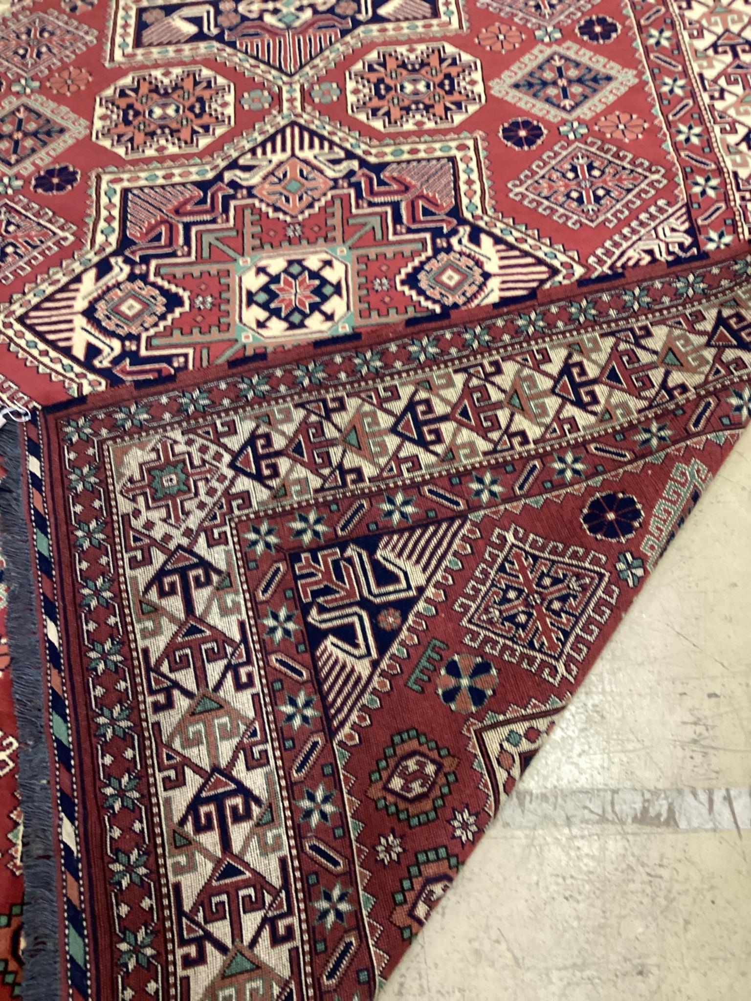 A modern Caucasian style red ground carpet 300cm x 210cm
